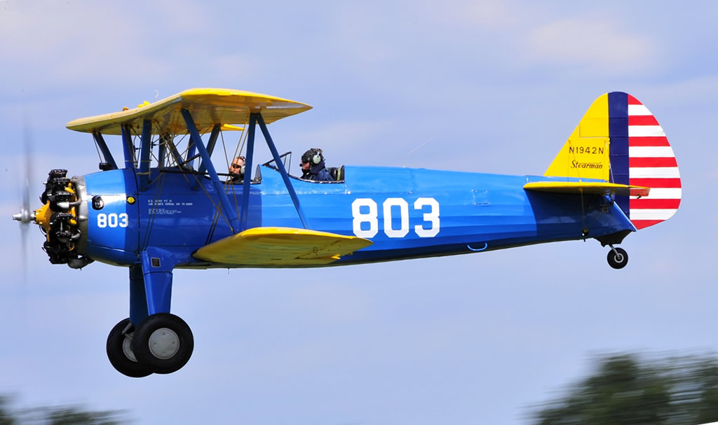 U.S. Army Air Force Stearman with yellow wings, blue fuselage and yellow tail surfaces with red-white stripes... seen here is N1942N
